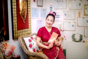 Atipa and the wall of her diplomas