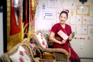 Atipa and the wall of her diplomas